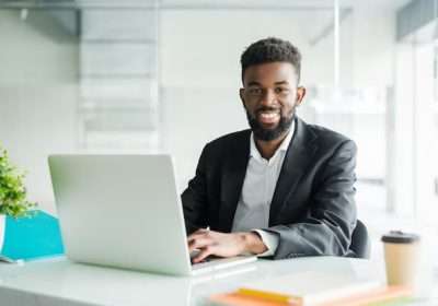 portrait-handsome-african-black-young-business-man-working-laptop-office-desk_231208-680-1